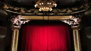 Vue frontale spectaculaire de la scène et du rideau rouge d'un opéra classique.